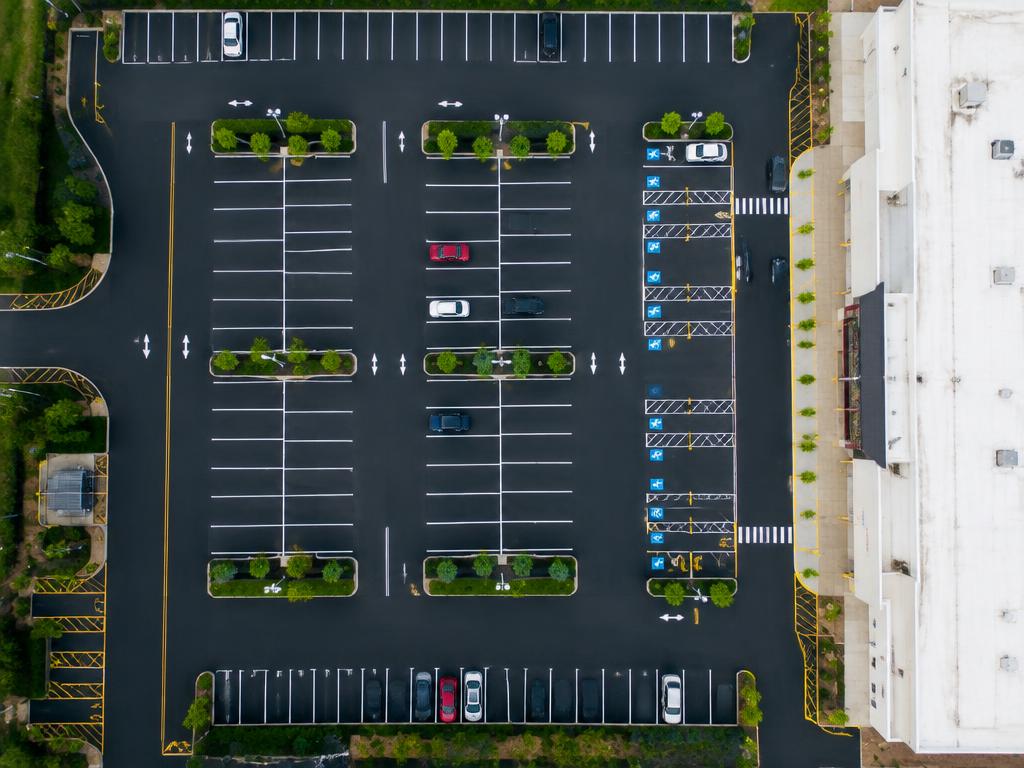 Aerial view of a commercial parking lot with fresh pavement markings